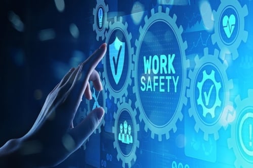 Hand interacting with a digital "Work Safety" interface.