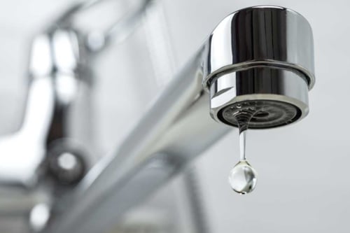 single drop of water falling from a tap