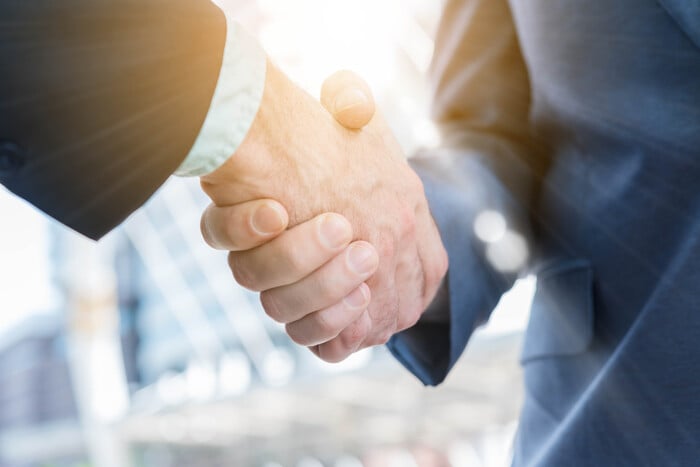 Close-up of two men shaking hand