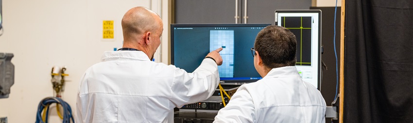 Two kiwa employees analyze PVEL's data on a laptop