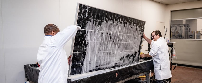 two kiwa specialists doing a module test on a solar panel 